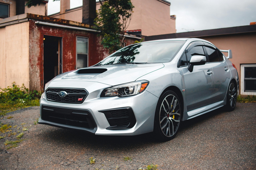 Shiny freshly detailed car with polished paint, clean wheels, and spotless interior.